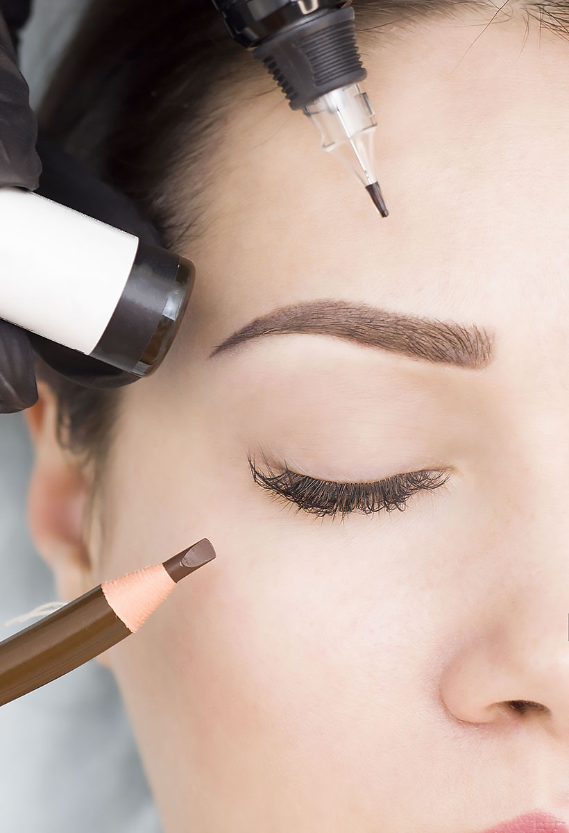 Permanent makeup. Permanent eyebrow tattoo. Cosmetologist applying permanent makeup on eyebrows - eyebrow tattoos. Tattooing. Microblading.