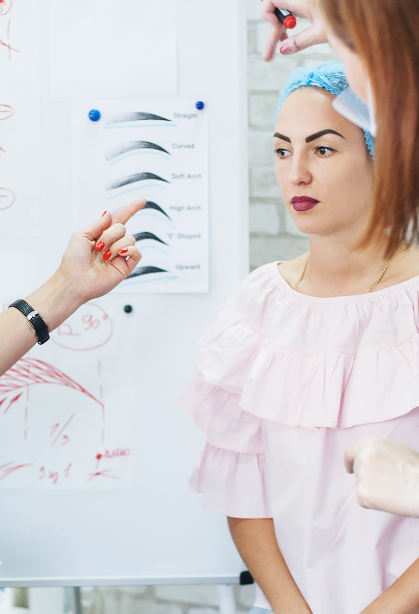 Permanent makeup. Professional courses. Female interns studying eyebrow design and new techniques.